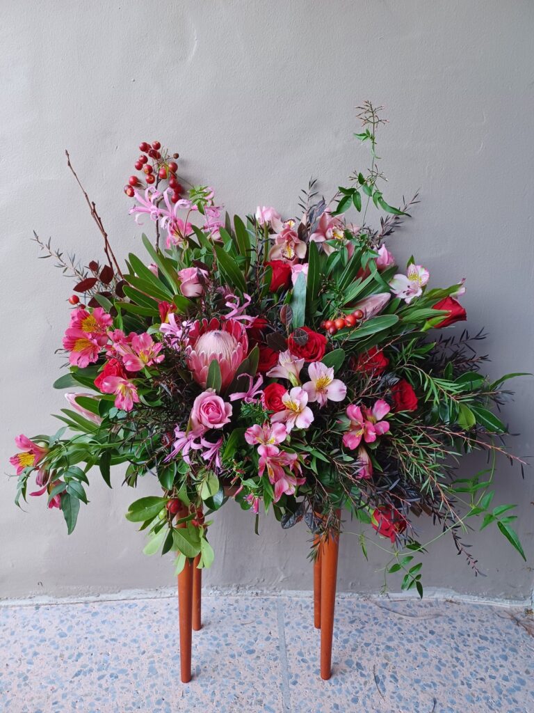 Kin Florist romantic wedding florals. Red garden style floor meadow floral wedding arrangement in Matakana.